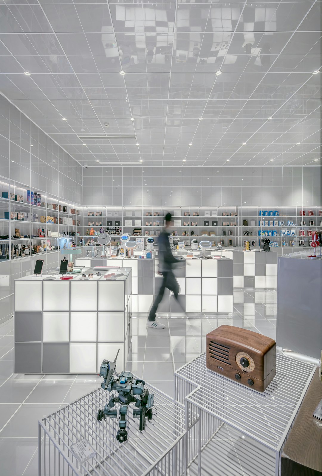 man walking beside white cube decoration man walking beside white cube decoration